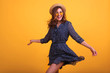 © ClaudiK - Studio image of elegant european female model dancing with excitement. Studio shot of slim brunette girl in summer dress jumping with happy face expression.Copy space