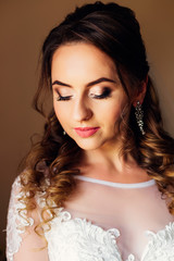 Close-up of the bride with a hairstyle and makeup that closed he