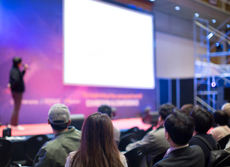 audience watching a presentation. defocused blurred presenter during conference meeting. investor pi