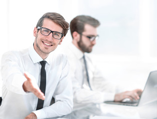 young businessman reaching out for a handshake.