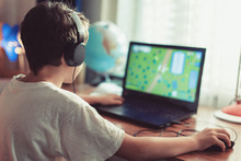 Little Dependent Gamer Kid Playing On Laptop At Home