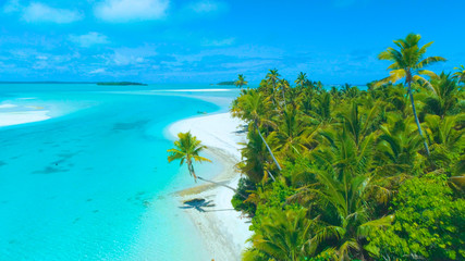 Wall Mural - AERIAL: Small boat is stuck on the sandy shore of the lush tropical island.