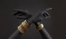 Black Woman's Hands With Gold Jewelry. Oriental Bracelets On A Black Painted Hand. Gold Jewelry And Luxury Accessories