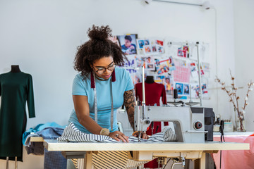 Professional female designer with one hand covered in tattoo