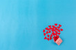 Valentines day background with red heart and gift box on blue background.
