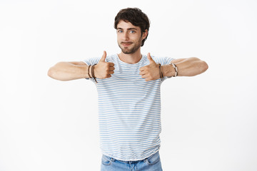 Guy accepting plan being eager to start working on new cool project giving positive opinion, liking idea smiling satisfied and showing thumbs up gesture with raised hands gazing enthusiastic at camera