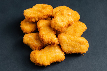 chicken nuggets on the black background