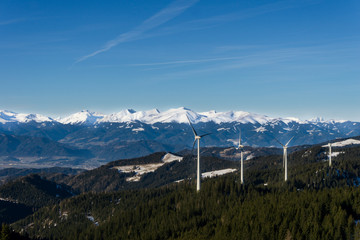  Distant view of snowy mountain peaks and windmills