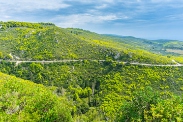 Greece, Zakynthos, Curved mountain road through green paradise like mountains and valleys