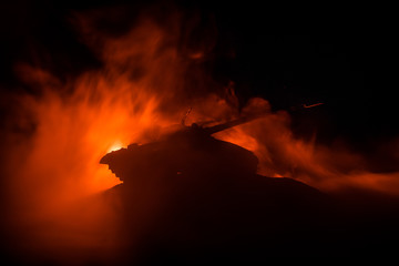 War Concept. Military silhouettes fighting scene on war fog sky background, World War German Tanks Silhouettes Below Cloudy Skyline At night. Attack scene. Armored vehicles. Tanks battle