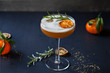 © Magdalena Bujak - Christmas cocktail of amaretto sour with dehydrated clementine and rosemary