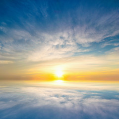 Wall Mural - Sky blue and orange light of the sun through the clouds in the sky
