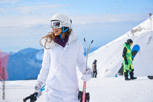 Fotomural woman skier close up portrait wearing white healmet with mask in snow winter mou