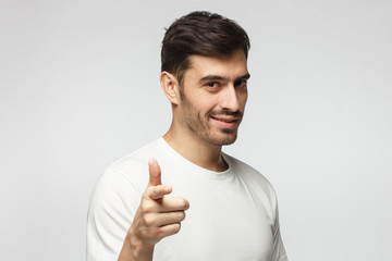 Wall Mural - Caucasian male pointing at camera, isolated on grey background