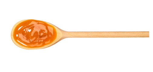 Poster - Orange sweet and sour sauce in  wooden spoon isolated on white background,top view