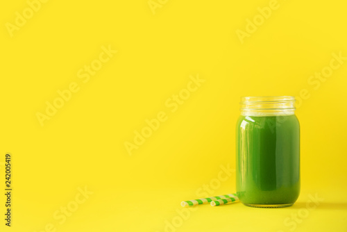 Bottle Of Green Celery Smoothie On Yellow Background Banner With