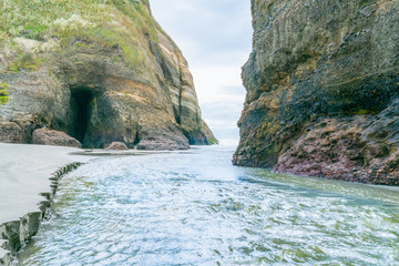 Water rushes between two high rock bluffs