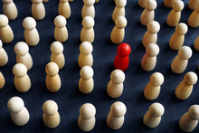 Unique, Individual And Think Differently. Crowd Of Wooden Figures And Red One.