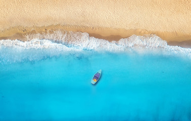 Wall Mural - seashore and boat from top view. turquoise water background from top view. summer seascape from air.