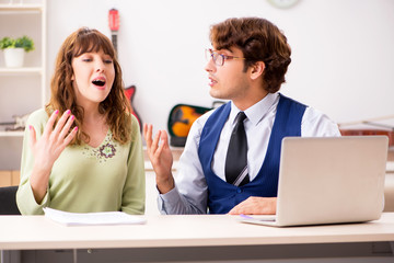 young woman during music lesson with male teacher