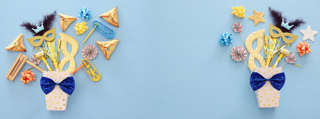 Purim celebration concept (jewish carnival holiday) over wooden blue background.