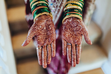 indian woman with henna tattoos for a wedding showing hands