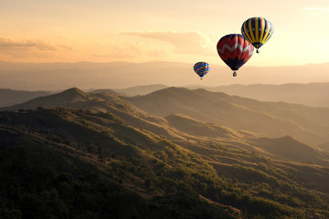 Hot air balloon flying over doi Chang at sunset ,Chiang Rai, Thailand