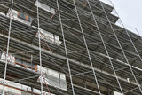 Fototapeta Kwiaty - new building under construction, scaffolding and concrete