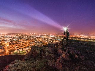 Wall Mural - adventurer / hiker with head lamp after sunset on arthur's seat above edinburgh, scotland