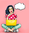 Thinking young sexy woman with open mouth looking up on empty bubble sitting with laptop.Pop Art girl is thought and holding hand near the face
