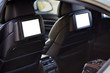 Car inside headrest screen mock up. Two white displays for back seats passenger with media control panel copy space and place for text