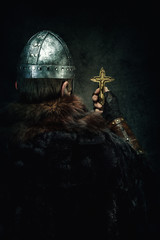 Wall Mural - Portrait of a Viking holding a Christian cross in his hand