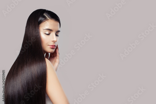 Attractive Woman With Long Healthy Straight Hair On Pink