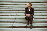 Fototapeta Na drzwi - Sad businesswoman sitting on the staircase in the city.
