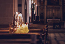 Young Woman Praying And Meditating In Church