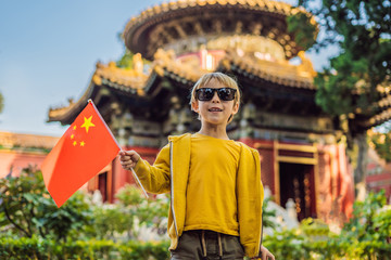 Enjoying vacation in China. Young boy with national chinese flag in Forbidden City. Travel to China with kids concept. Visa free transit 72 hours, 144 hours in China