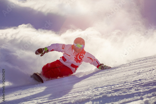 Fotomural snowboarder makes a turn, touching the track with his hand