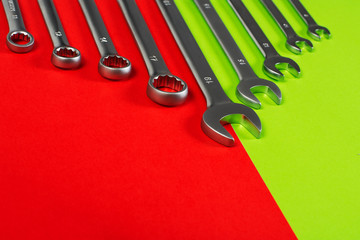 Canvas Print - wrench on green and red background screwdriver