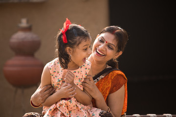 portrait of loving Indian mother and daughter at village