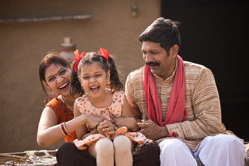 Wall Mural - Loving Indian parents and daughter at village