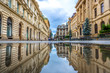 Bucharest, Romania - July 6th 2018 - The old town of Bucharest seen through a water reflection with people in the background in Romania