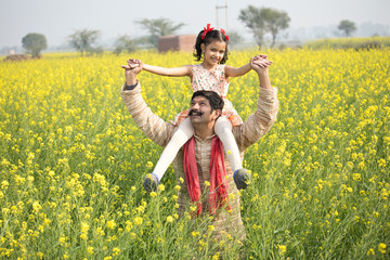 Wall Mural - Portrait of happy rural family in rapeseed agricultural field