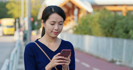 Canvas Print - Woman use of mobile phone in the park