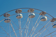 Retro Toned Part Of Big Wheel In Amusement Park Against Clear Summer Blue Sky.  Front View.
