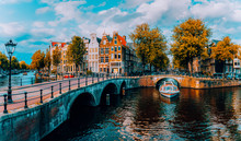 Panorama Of Amsterdam. Famous Canals Und Bridges At Warm Afternoon Light. Netherlands