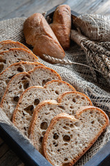 Slices of tasty whole wheat bread on a wooden table. Close-up