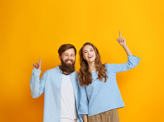 Wall Mural - couple of emotional people man and woman on yellow background.