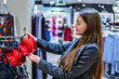 © Igor Kardasov - young beautiful woman finding herself new lingerie underwear in supermarket mall