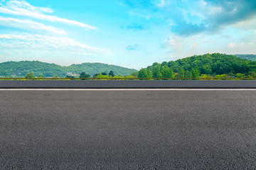 Empty asphalt road and natural landscape under the blue sky