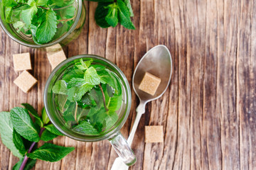 Canvas Print - Cup of Mint tea on wooden background